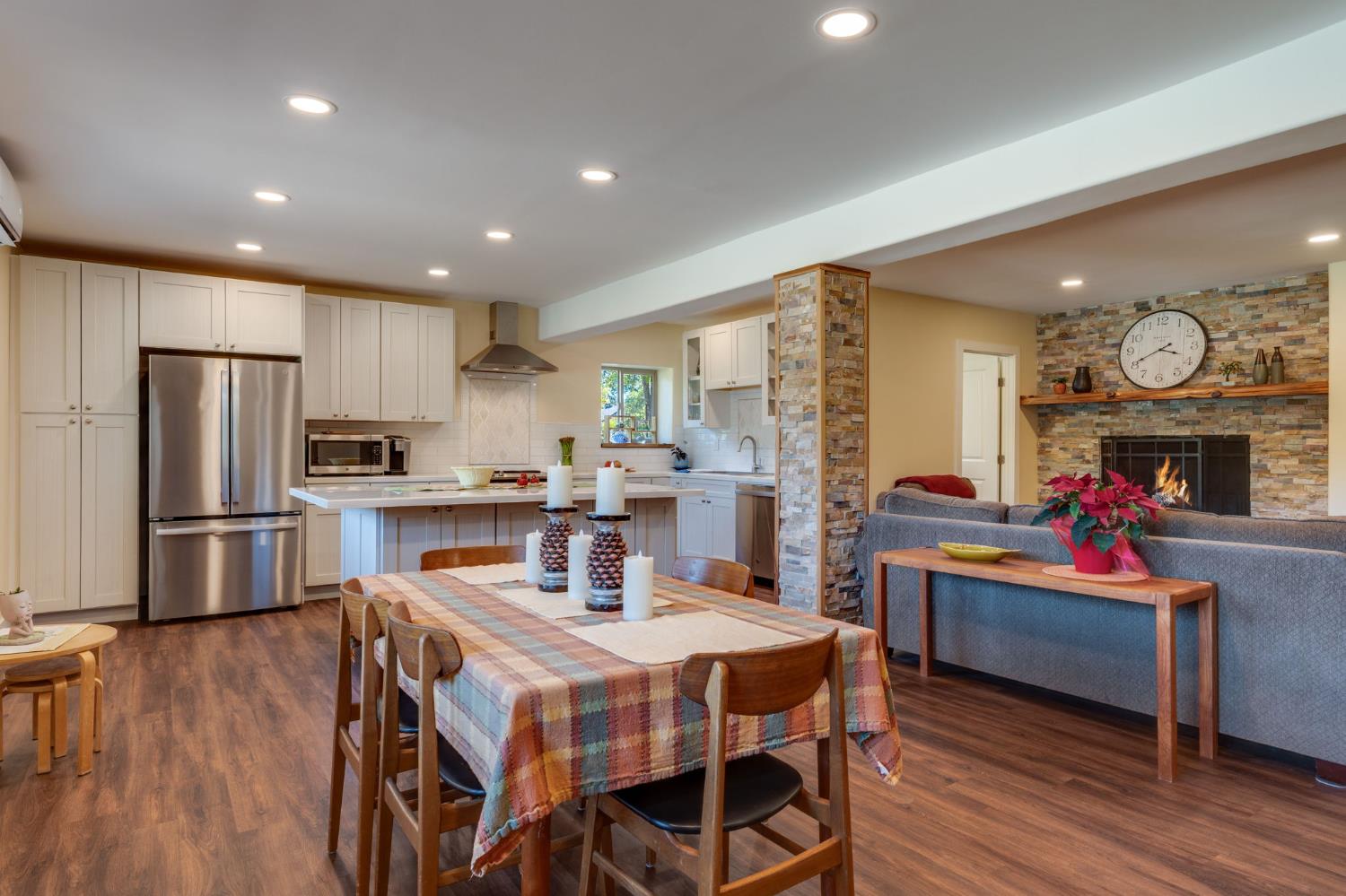 4600 El Caminito Road Shingle Springs, CA 95682 - Photo 38 of 76 a kitchen with stainless steel appliances granite countertop a refrigerator a stove top oven a dining table and chairs with wooden floor
