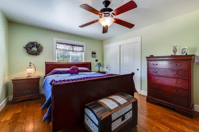 a bedroom with a bed and a chandelier