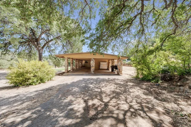 a kitchen with granite countertop stainless steel appliances and wooden cabinets