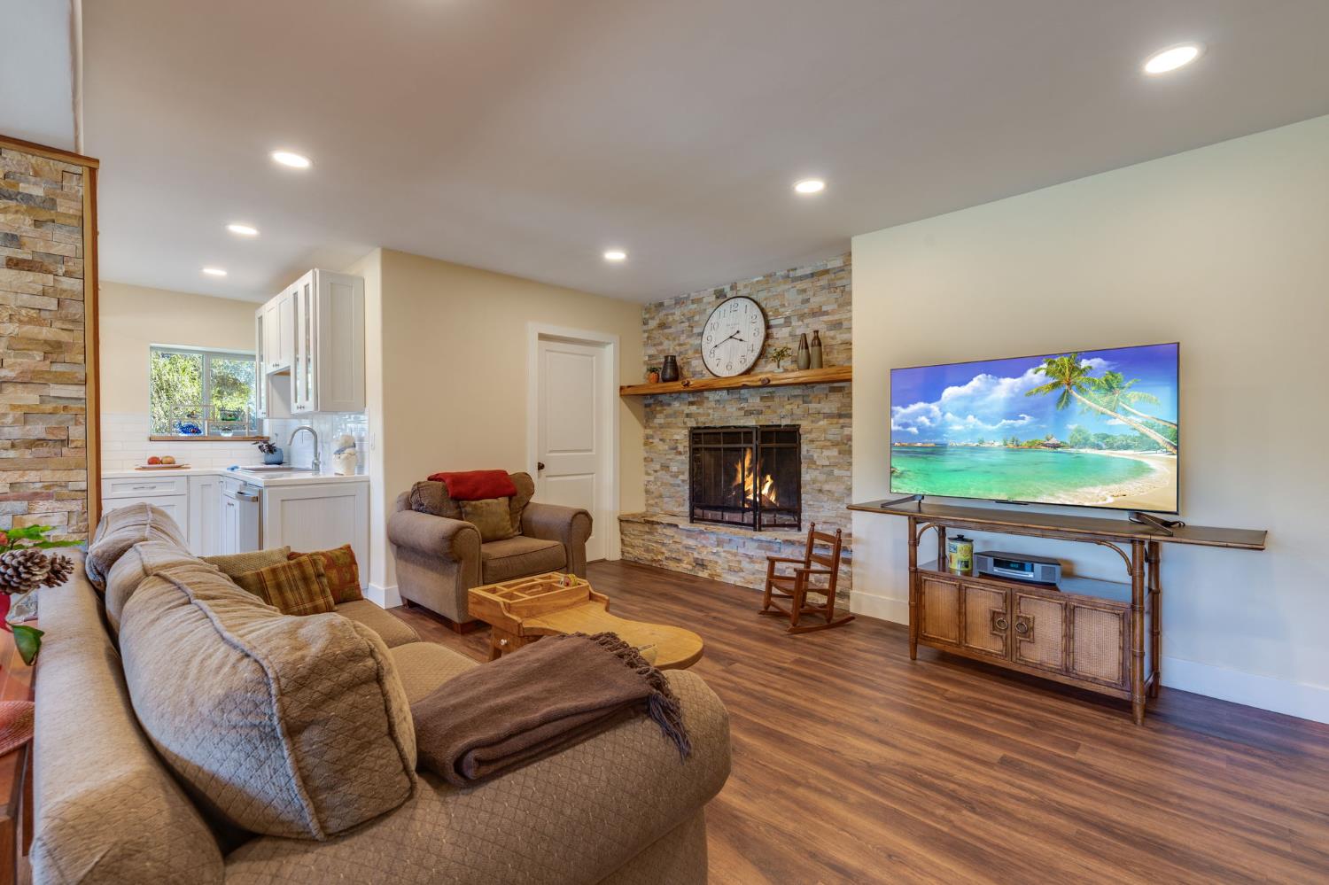 4600 El Caminito Road Shingle Springs, CA 95682 - Photo 72 of 76 a living room with furniture a flat screen tv and a fireplace