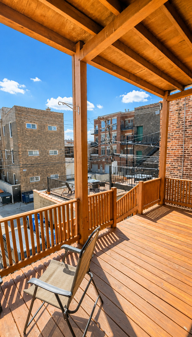 921 South Bishop Street, Unit 2 Chicago, IL 60607 - Photo 2 of 14 a view of a balcony with a large window and wooden floor
