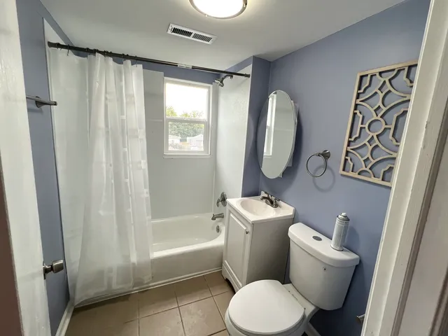 a white toilet sitting next to a bathroom sink and tub