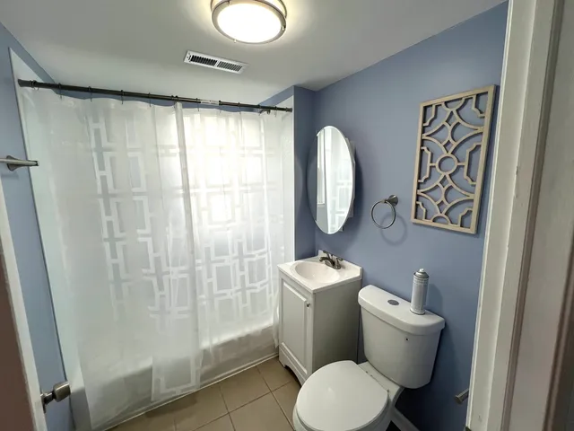 a white toilet sitting next to a bathroom sink