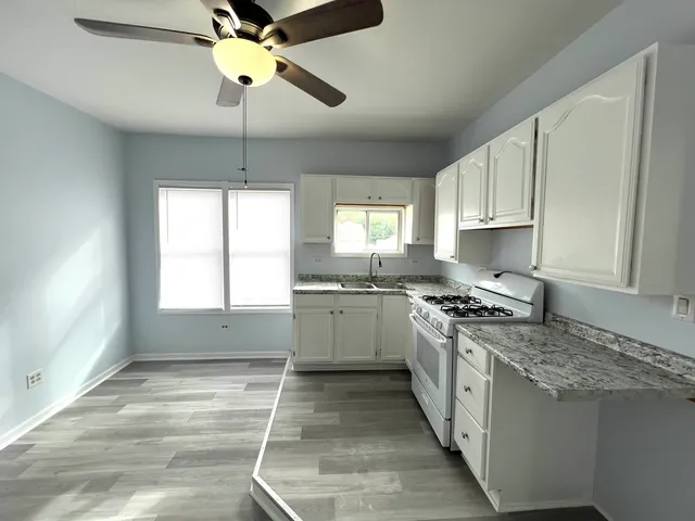 a kitchen with a stove a sink and a refrigerator