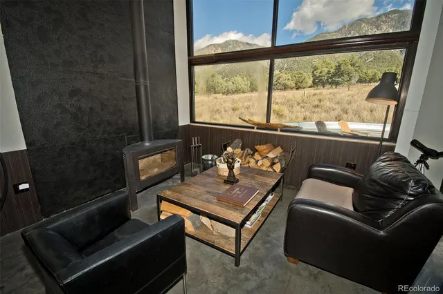 a living room with furniture and a floor to ceiling window