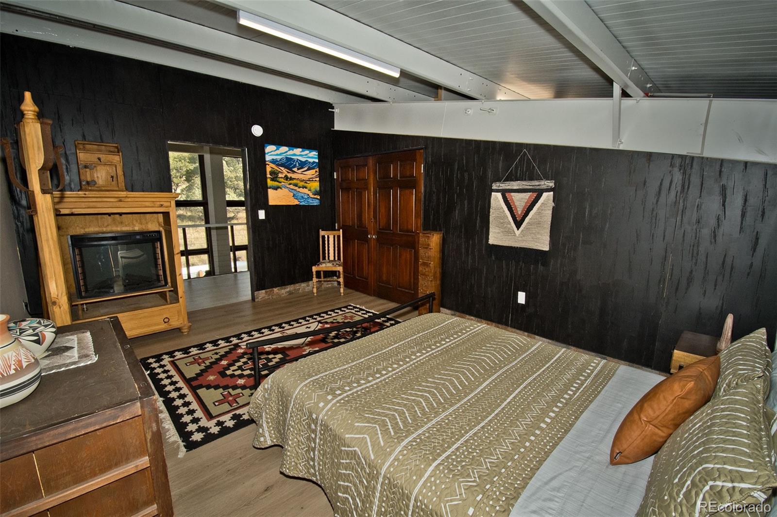 5 North Baca Grant Way Crestone, CO 81131 - Photo 30 of 42 a bedroom with a bed and dresser