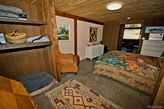 a room with furniture a mirror and gym equipment