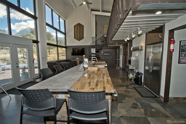 a dining room with furniture and a floor to ceiling window