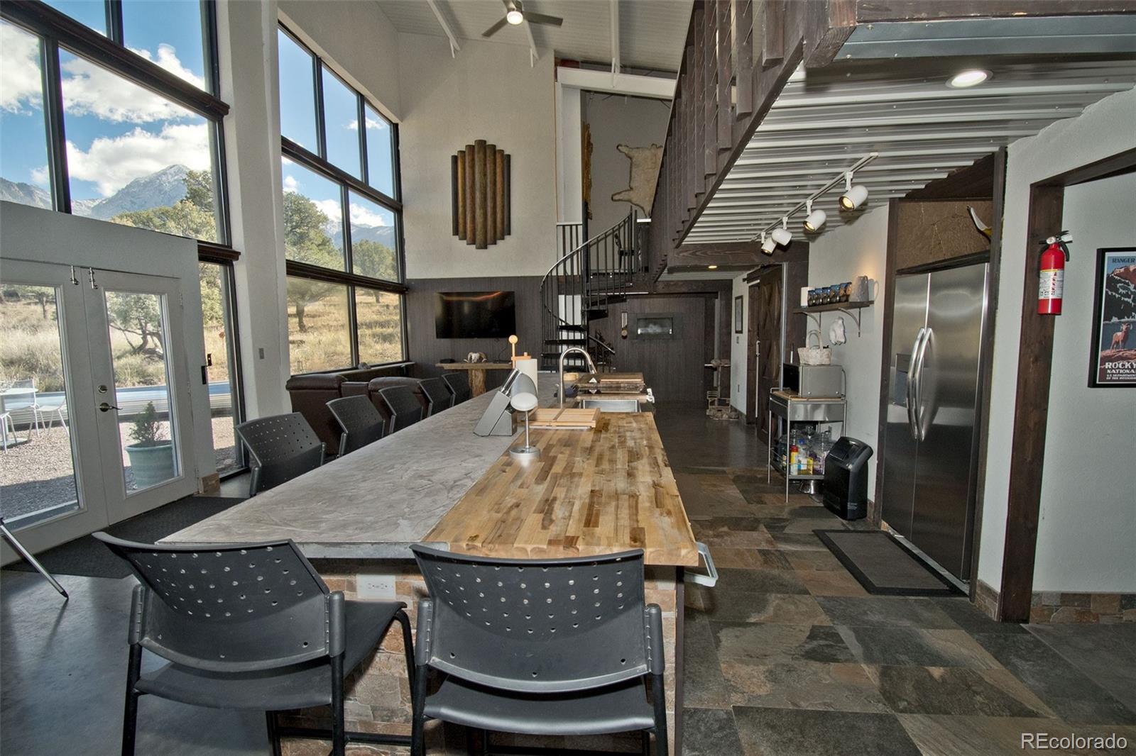 5 North Baca Grant Way Crestone, CO 81131 - Photo 7 of 42 a dining room with furniture and a floor to ceiling window