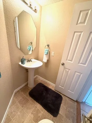 a room with a washing machine and sink