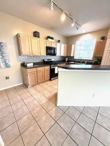 a kitchen with stainless steel appliances kitchen island granite countertop a sink and cabinets