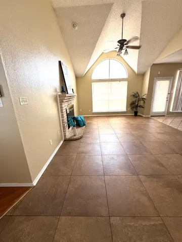 a large kitchen with granite countertop a stove a sink a counter space and cabinets