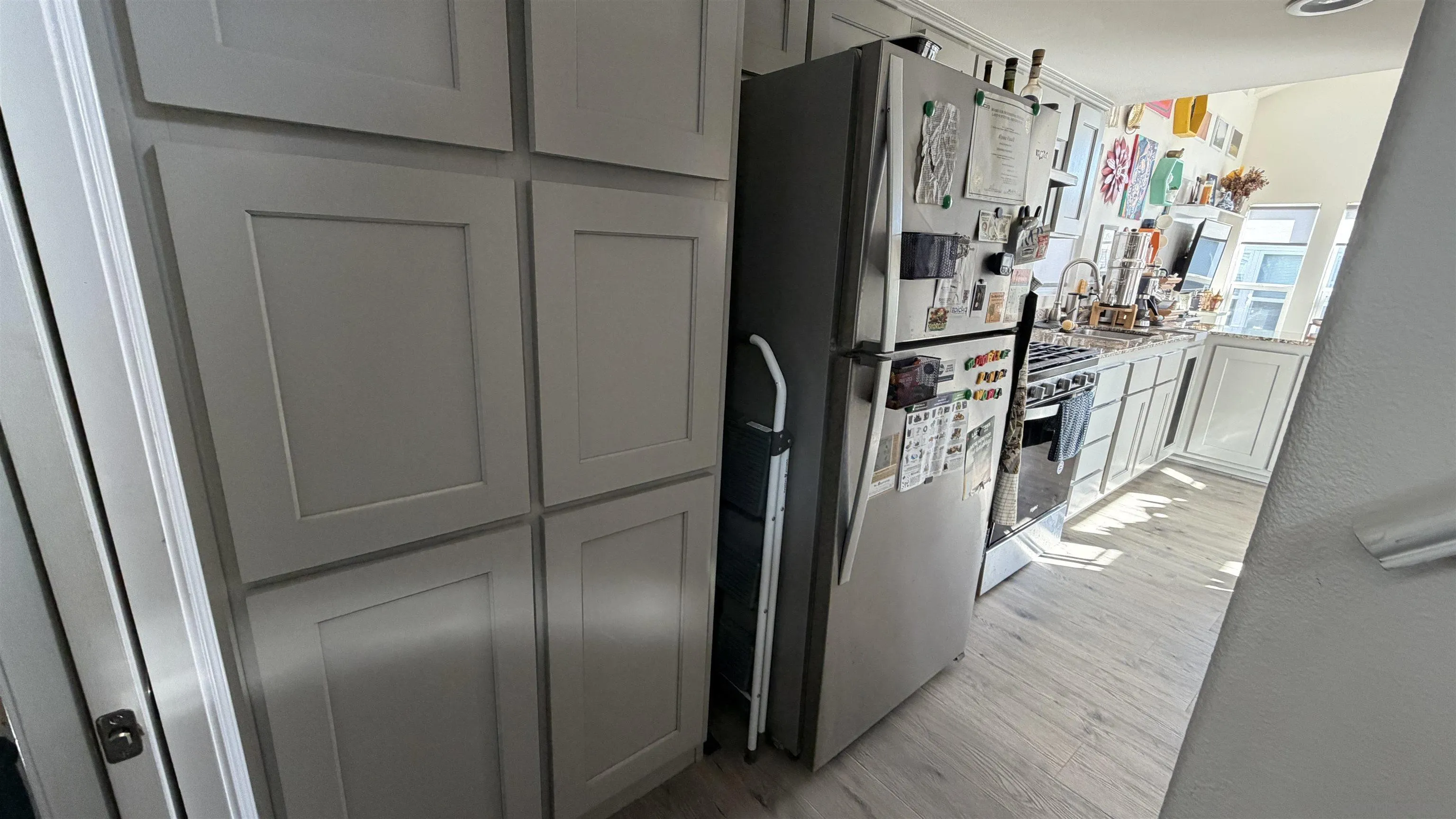 1549 North Vulcan Avenue, Unit 82 Encinitas, CA 92024 - Photo 12 of 32 a view of a refrigerator in kitchen and wooden floor