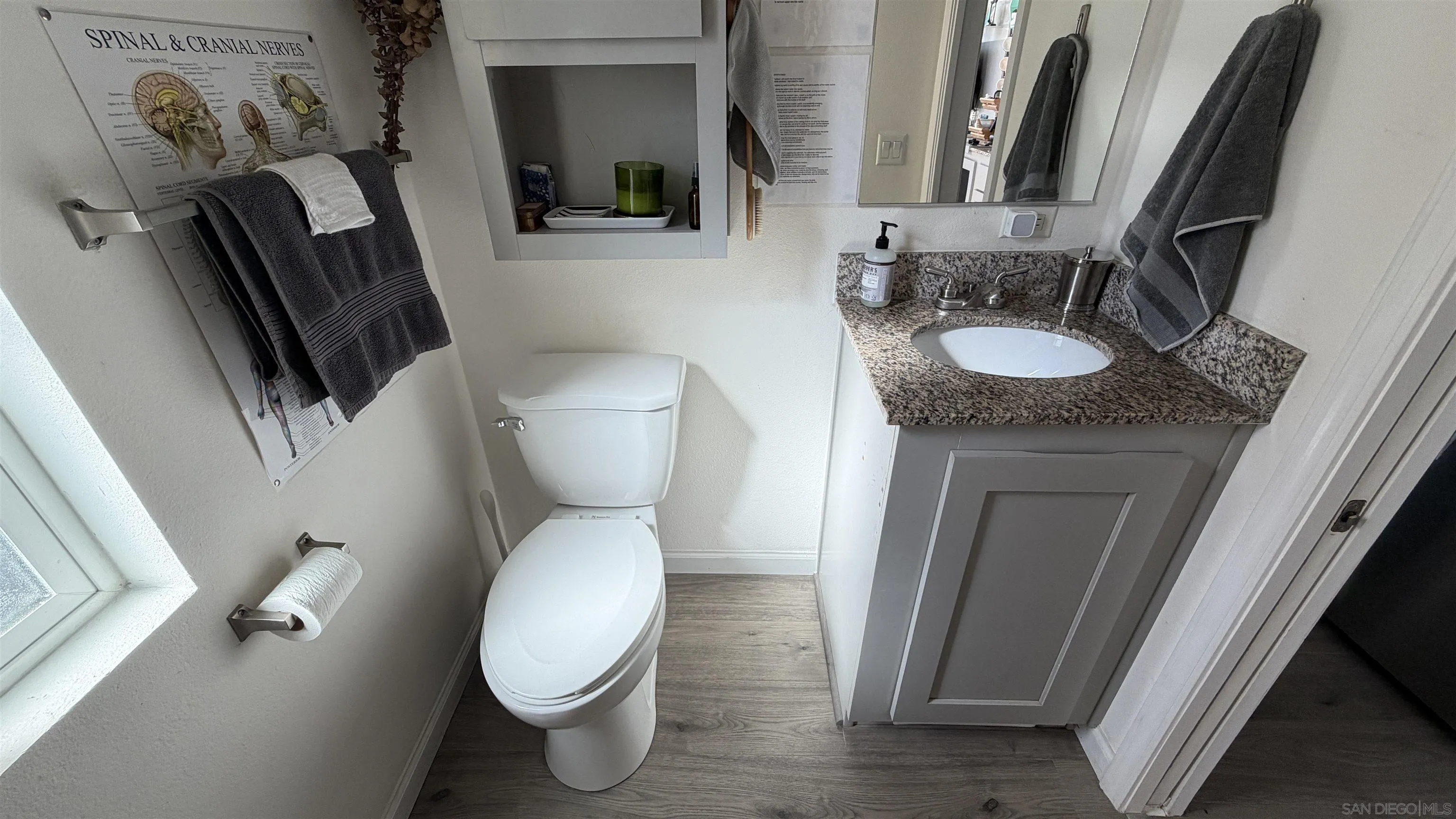 1549 North Vulcan Avenue, Unit 82 Encinitas, CA 92024 - Photo 13 of 32 a white toilet sitting next to a bathroom sink