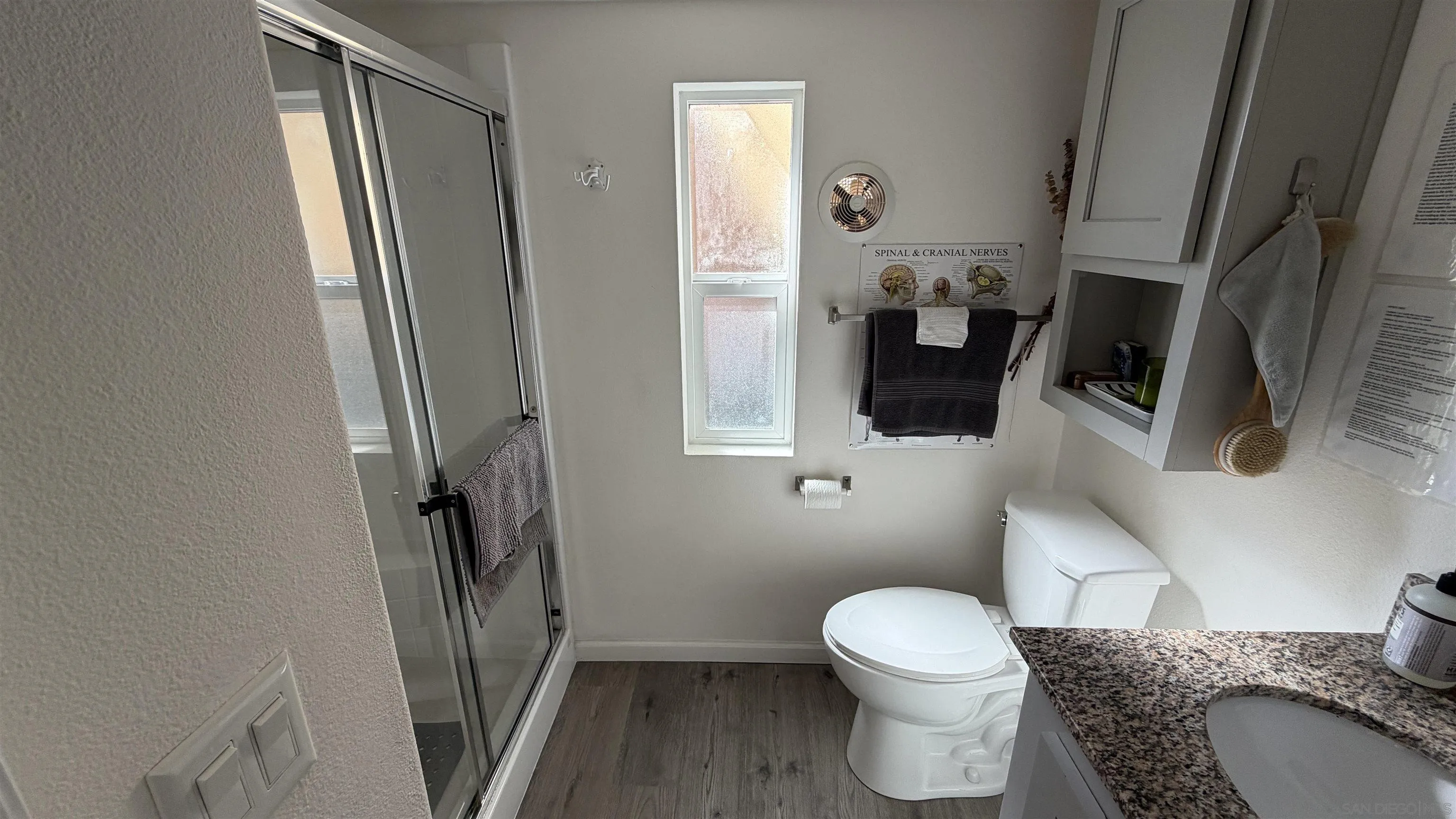 1549 North Vulcan Avenue, Unit 82 Encinitas, CA 92024 - Photo 14 of 32 a bathroom with a granite countertop toilet and a sink