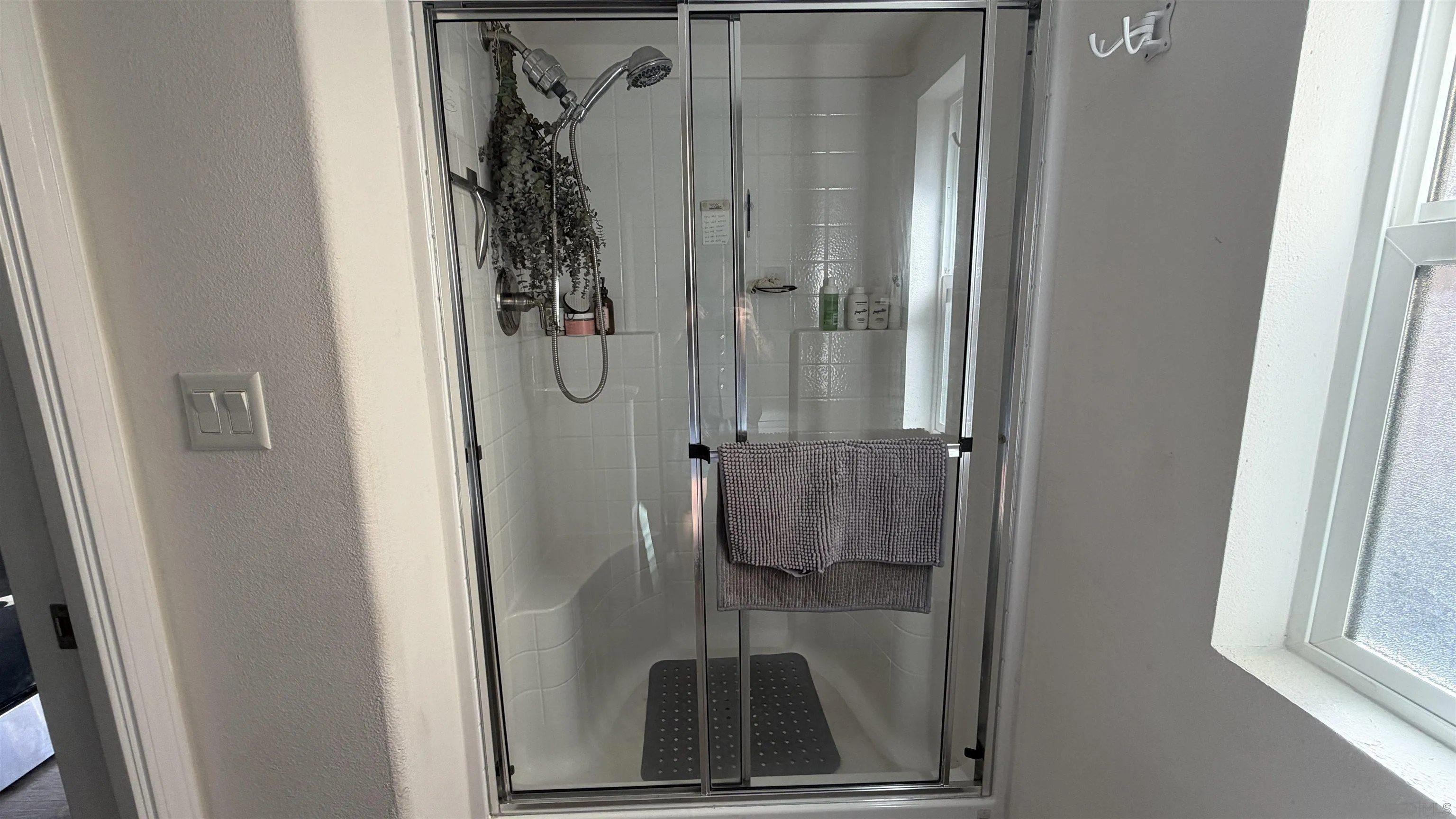 1549 North Vulcan Avenue, Unit 82 Encinitas, CA 92024 - Photo 15 of 32 a bathroom with a glass shower door