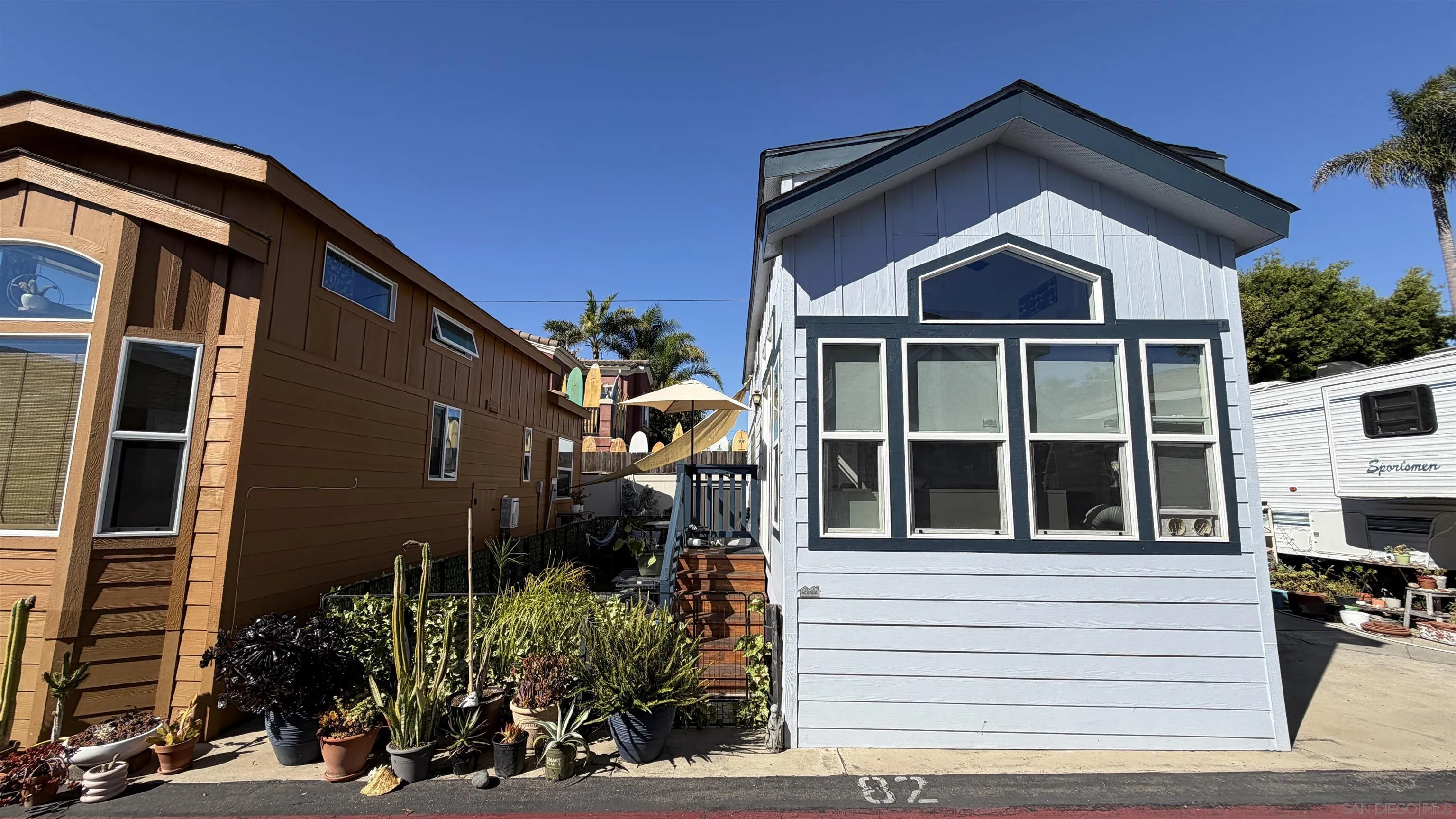 1549 North Vulcan Avenue, Unit 82 Encinitas, CA 92024 - Photo 2 of 32 a front view of a house with a yard