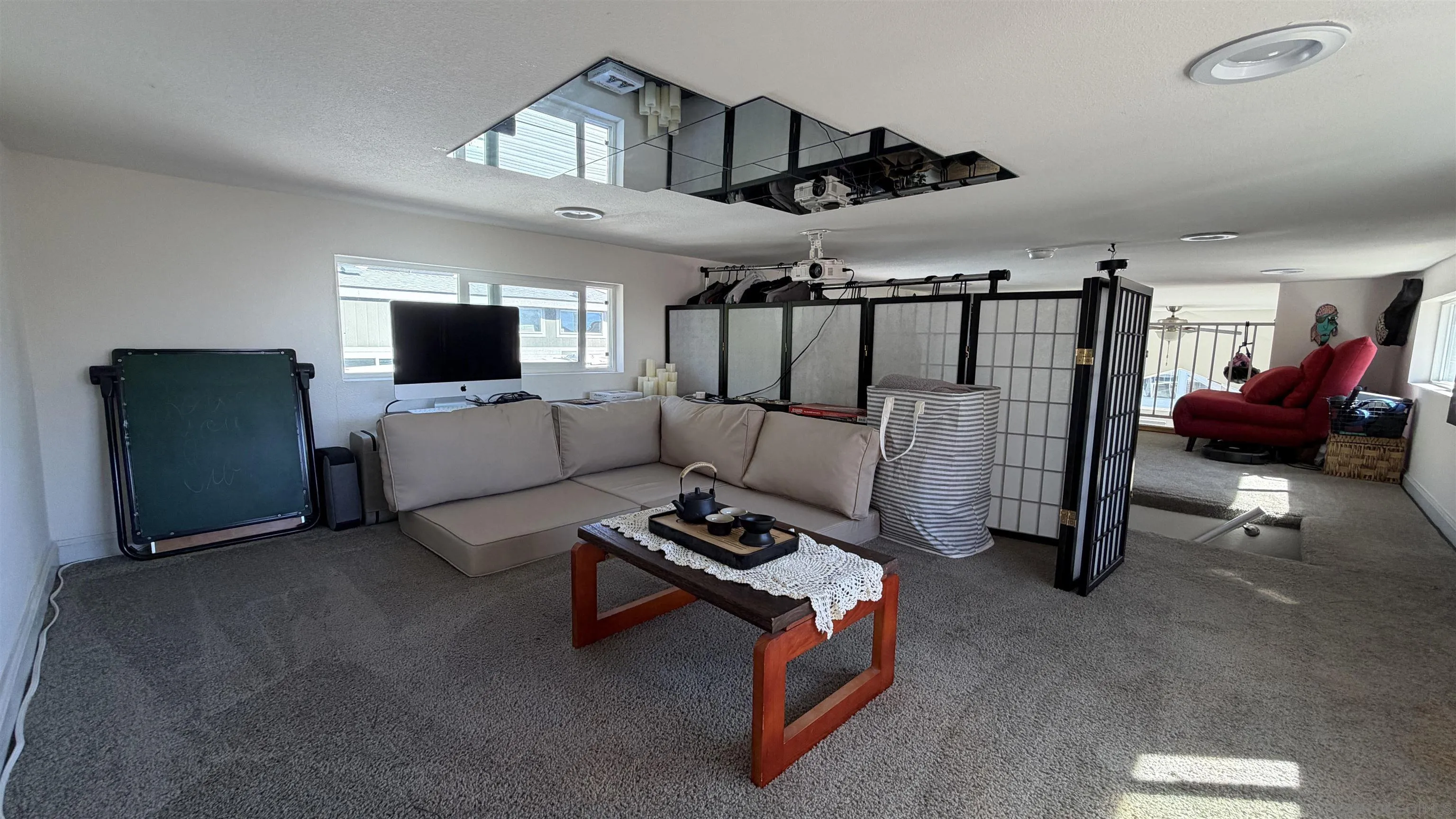 1549 North Vulcan Avenue, Unit 82 Encinitas, CA 92024 - Photo 25 of 32 a bedroom with furniture and a flat screen tv