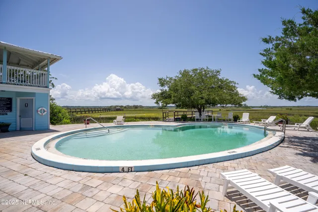 a view of a swimming pool with an outdoor seating