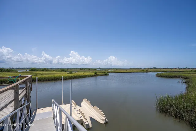 a view of a lake with couches in the patio