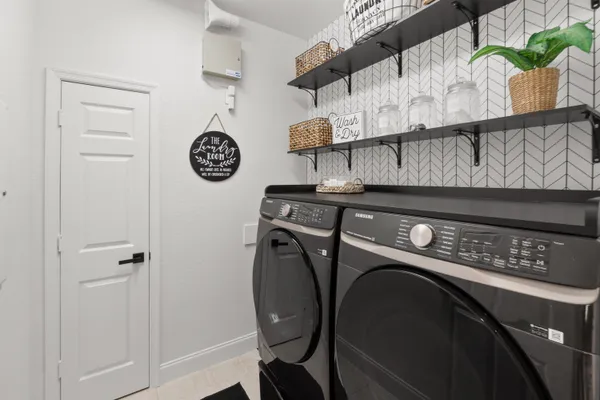 a kitchen with stainless steel appliances a refrigerator and microwave