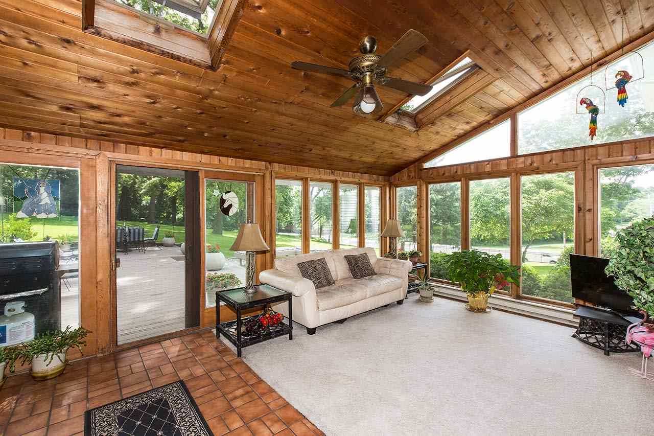 3604 Spring Creek Road Rockford, IL 61107 - Photo 12 of 24 a living room with patio furniture and a floor to ceiling window