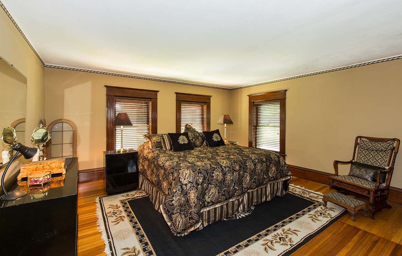 3604 Spring Creek Road Rockford, IL 61107 - Photo 17 of 24 a bed room with a bed and a chair