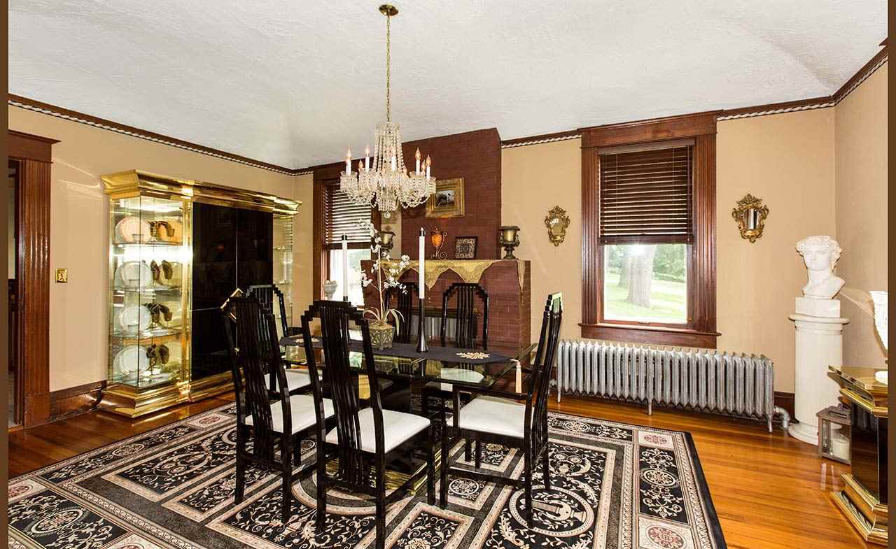 3604 Spring Creek Road Rockford, IL 61107 - Photo 4 of 24 a view of a dining room and livingroom with furniture wooden floor a chandelier