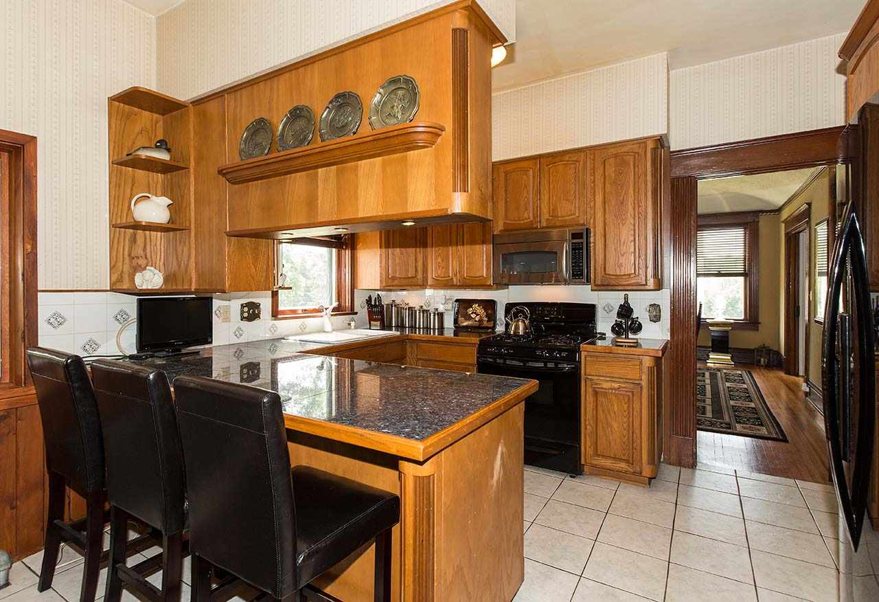 3604 Spring Creek Road Rockford, IL 61107 - Photo 8 of 24 a kitchen with stainless steel appliances granite countertop a stove top oven a sink a counter top space and cabinets