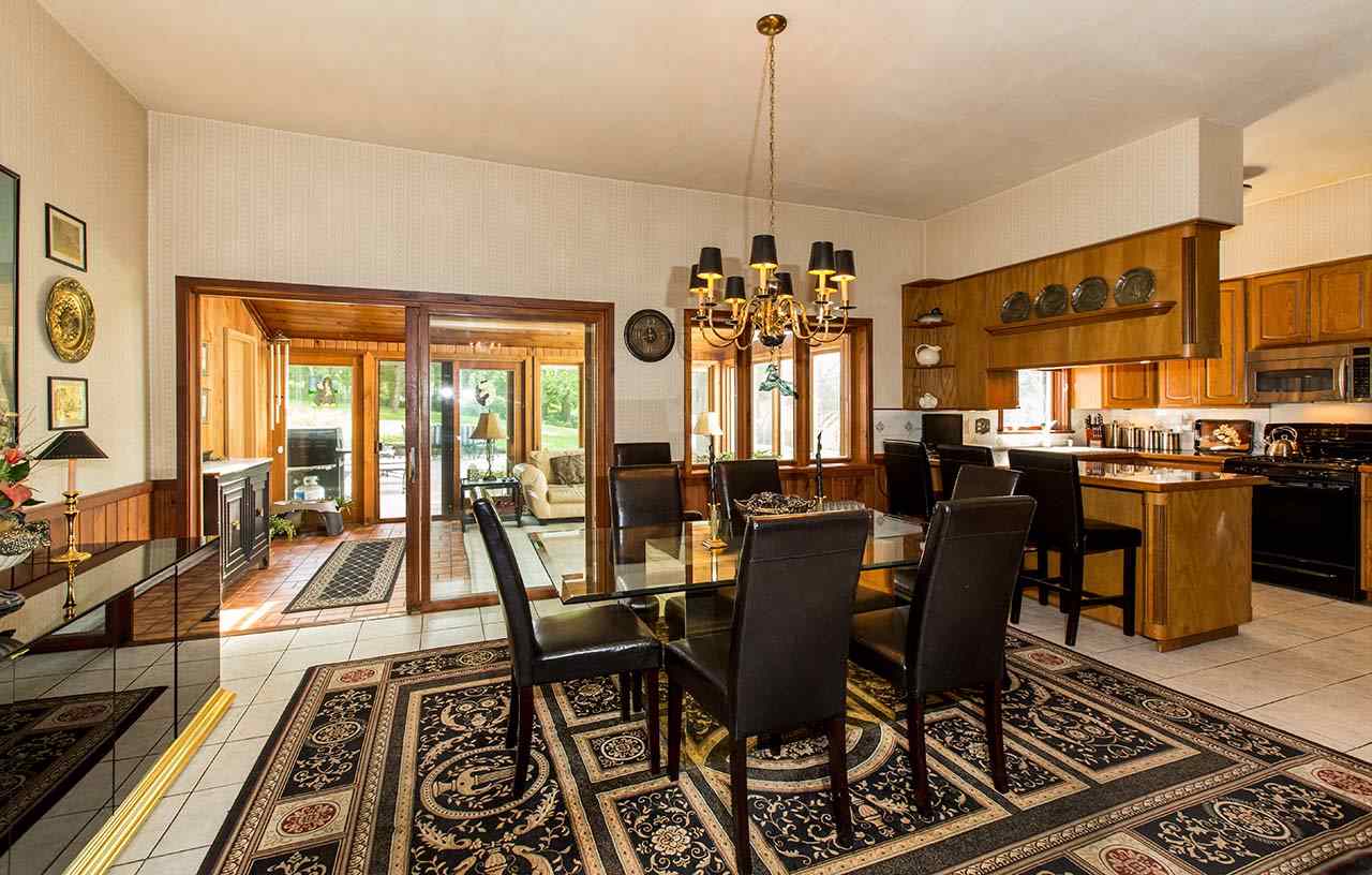 3604 Spring Creek Road Rockford, IL 61107 - Photo 10 of 24 a view of a dining room with furniture a chandelier and wooden floor