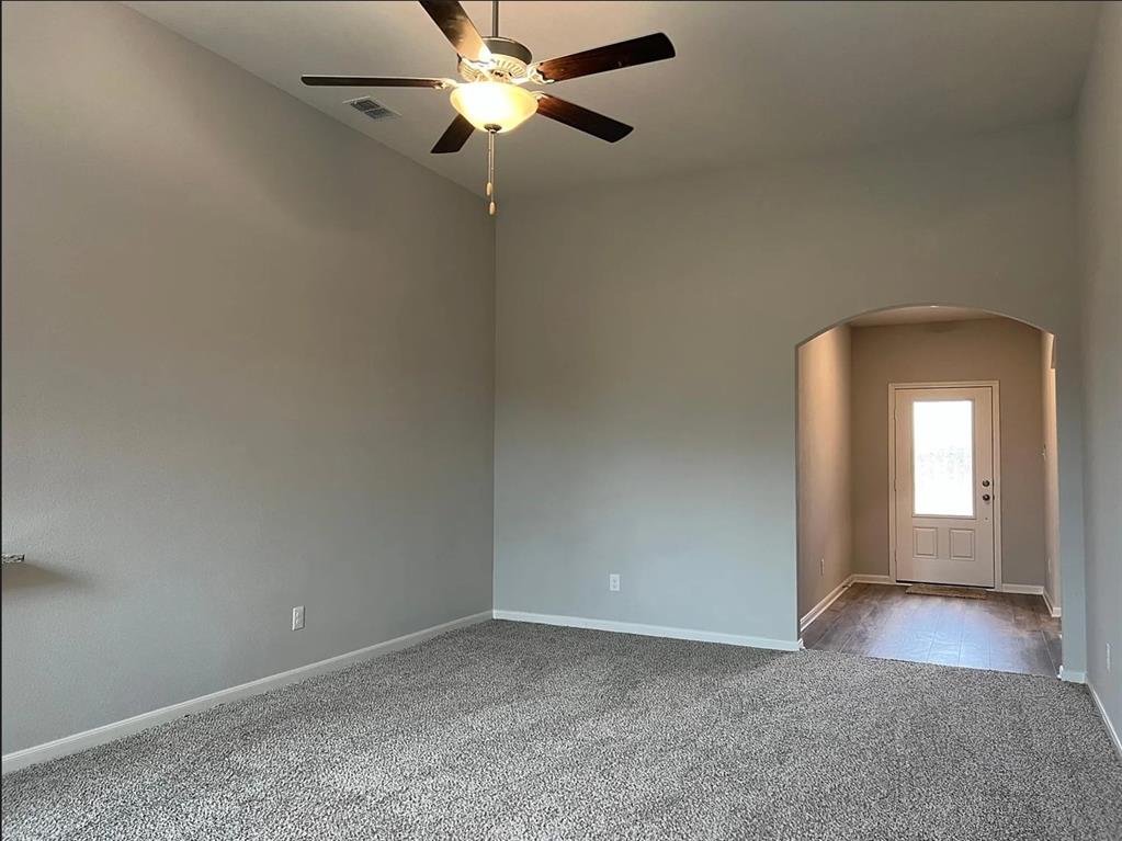 2013 Emma Court Anna, TX 75409 - Photo 7 of 20 Spacious room featuring vaulted ceilings, a ceiling fan with light fixture, and plush carpeting