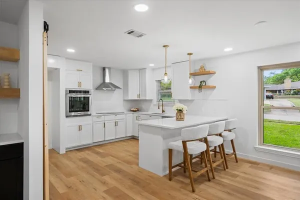 a kitchen with granite countertop white cabinets and stainless steel appliances