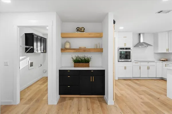 a workspace with wooden floor and windows