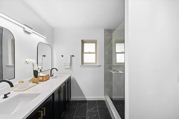 a bathroom with a shower and a sink