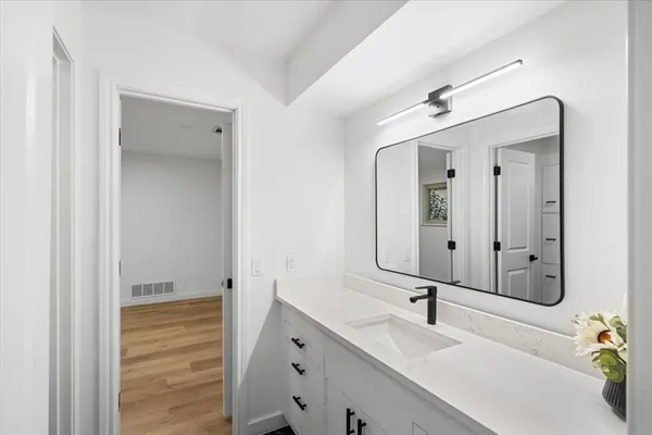 a view of a hallway with wooden floor and closet