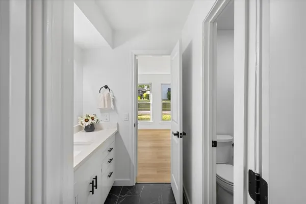 a bathroom with a toilet a sink and a mirror