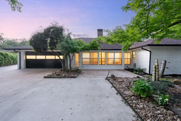 an aerial view of a house with a yard and garden