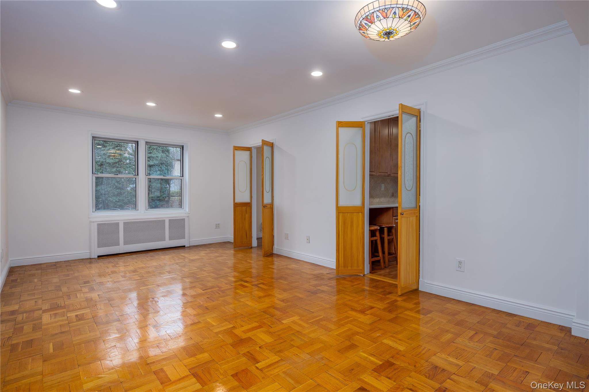2303 Palmer Avenue, Unit F New Rochelle, NY 10801 - Photo 4 of 22 Living room featuring radiator, recessed lighting, baseboards, and ornamental molding