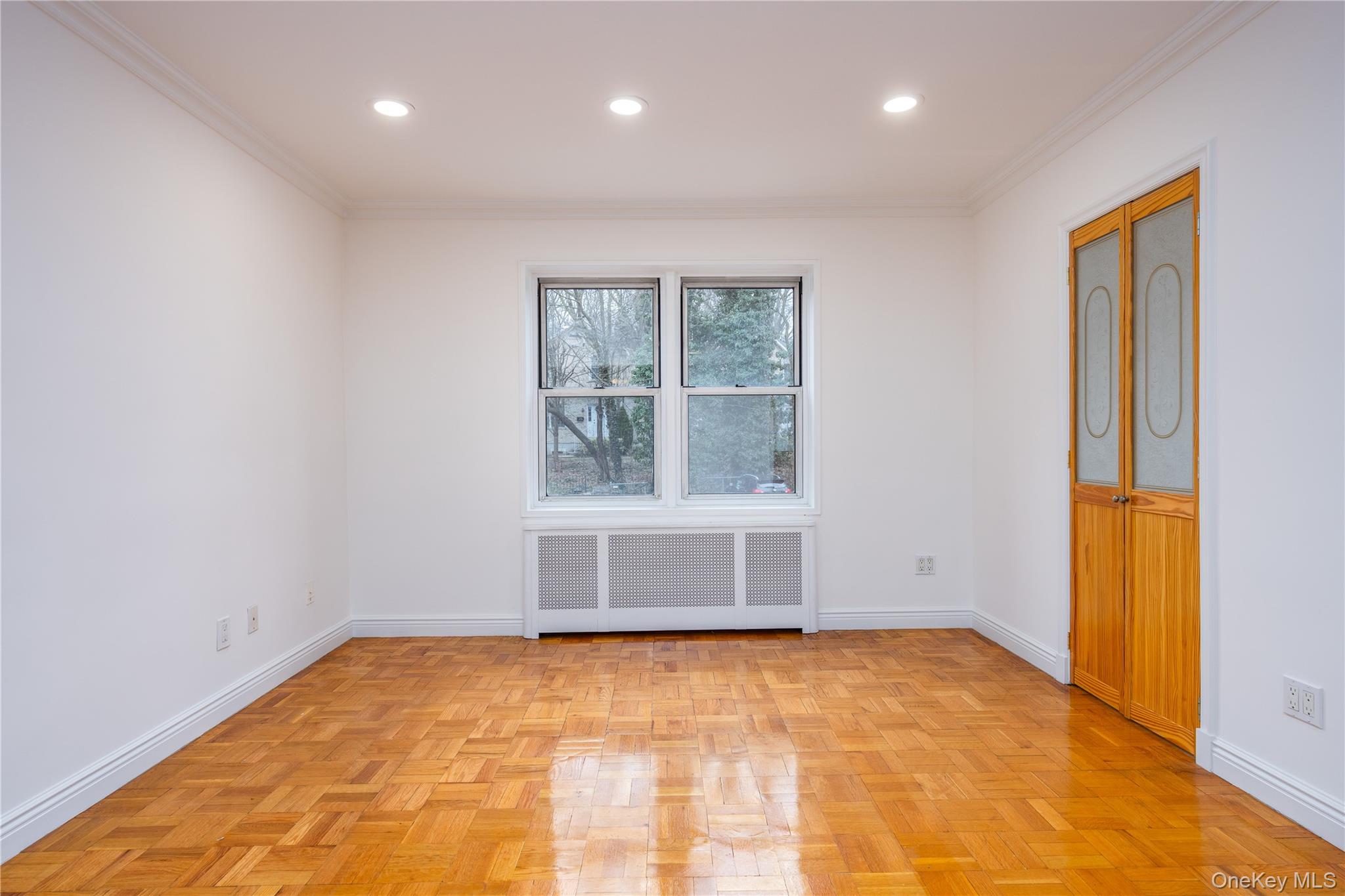 2303 Palmer Avenue, Unit F New Rochelle, NY 10801 - Photo 5 of 22 Empty room with baseboards, radiator heating unit, and ornamental molding