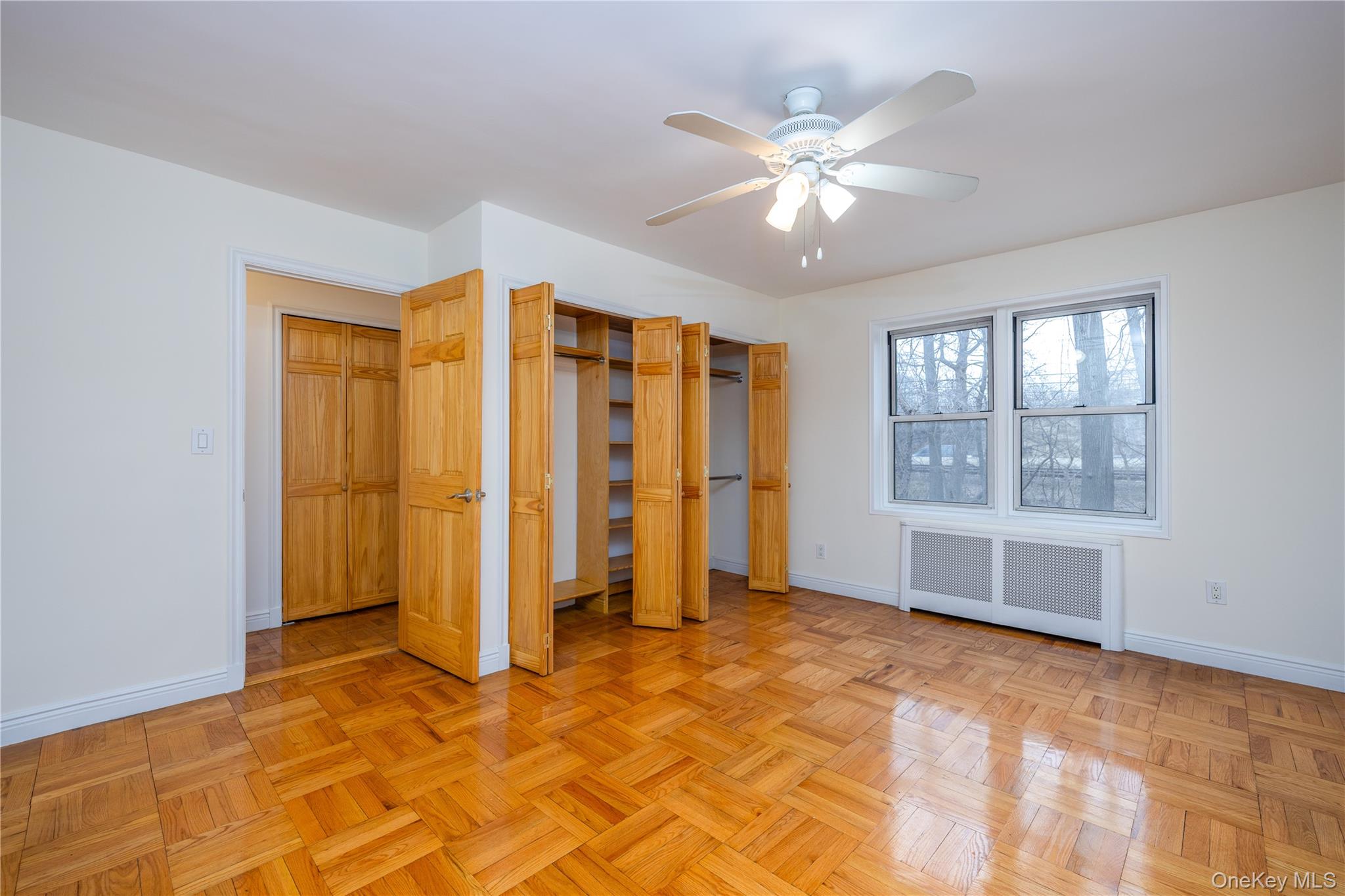 2303 Palmer Avenue, Unit F New Rochelle, NY 10801 - Photo 9 of 22 Primary bedroom with baseboards, ceiling fan, a closet, and radiator
