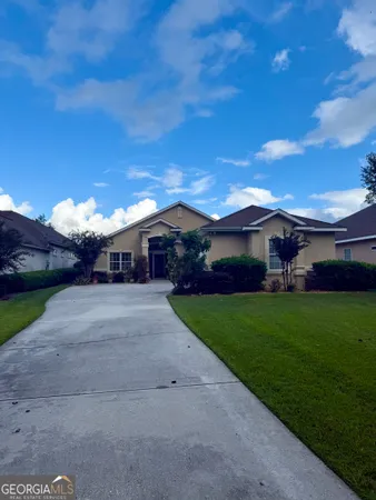 a front view of house with yard and green space