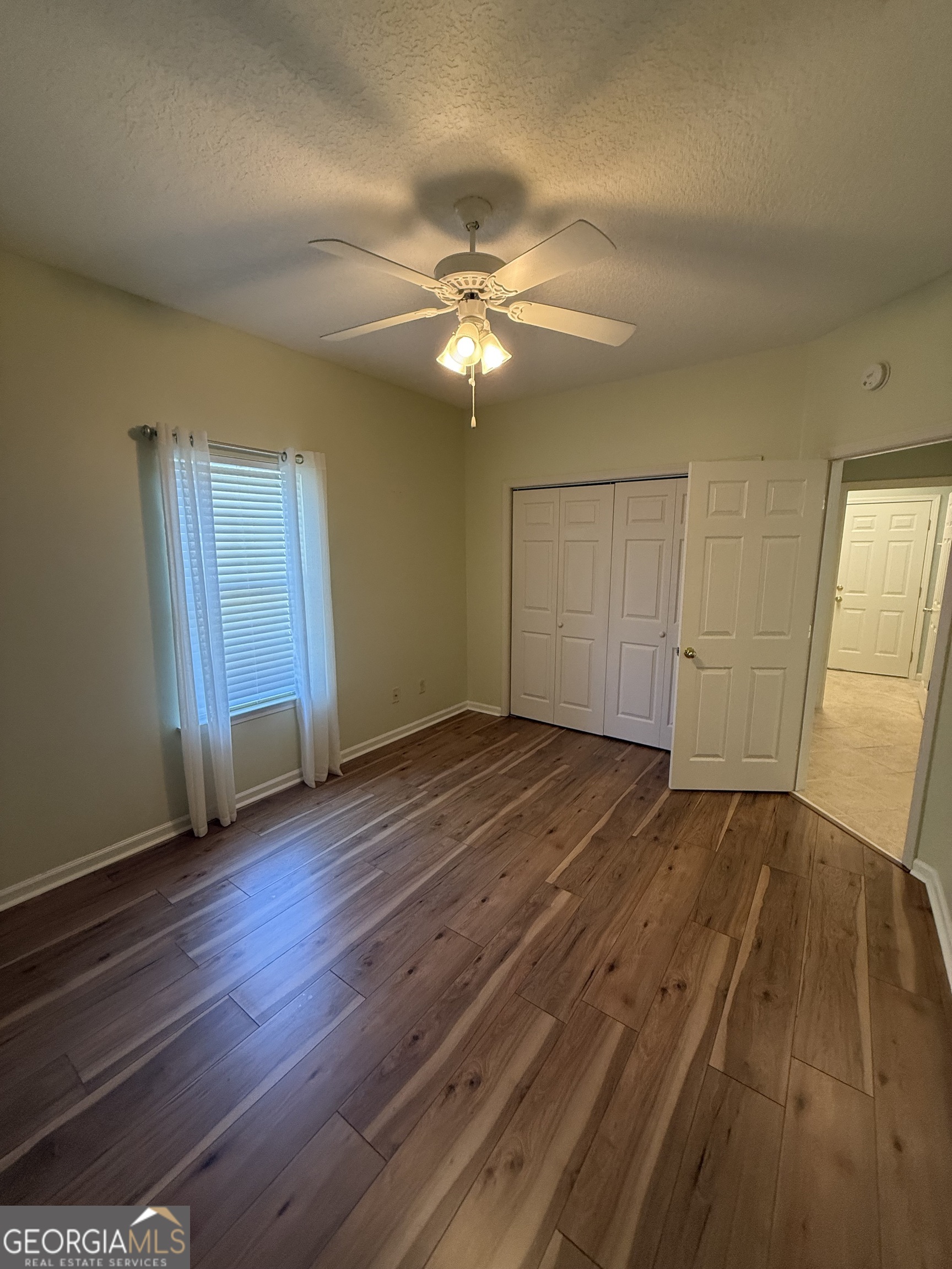 1403 Tanager Trail St. Marys, GA 31558 - Photo 12 of 24 an empty room with wooden floor closet and windows