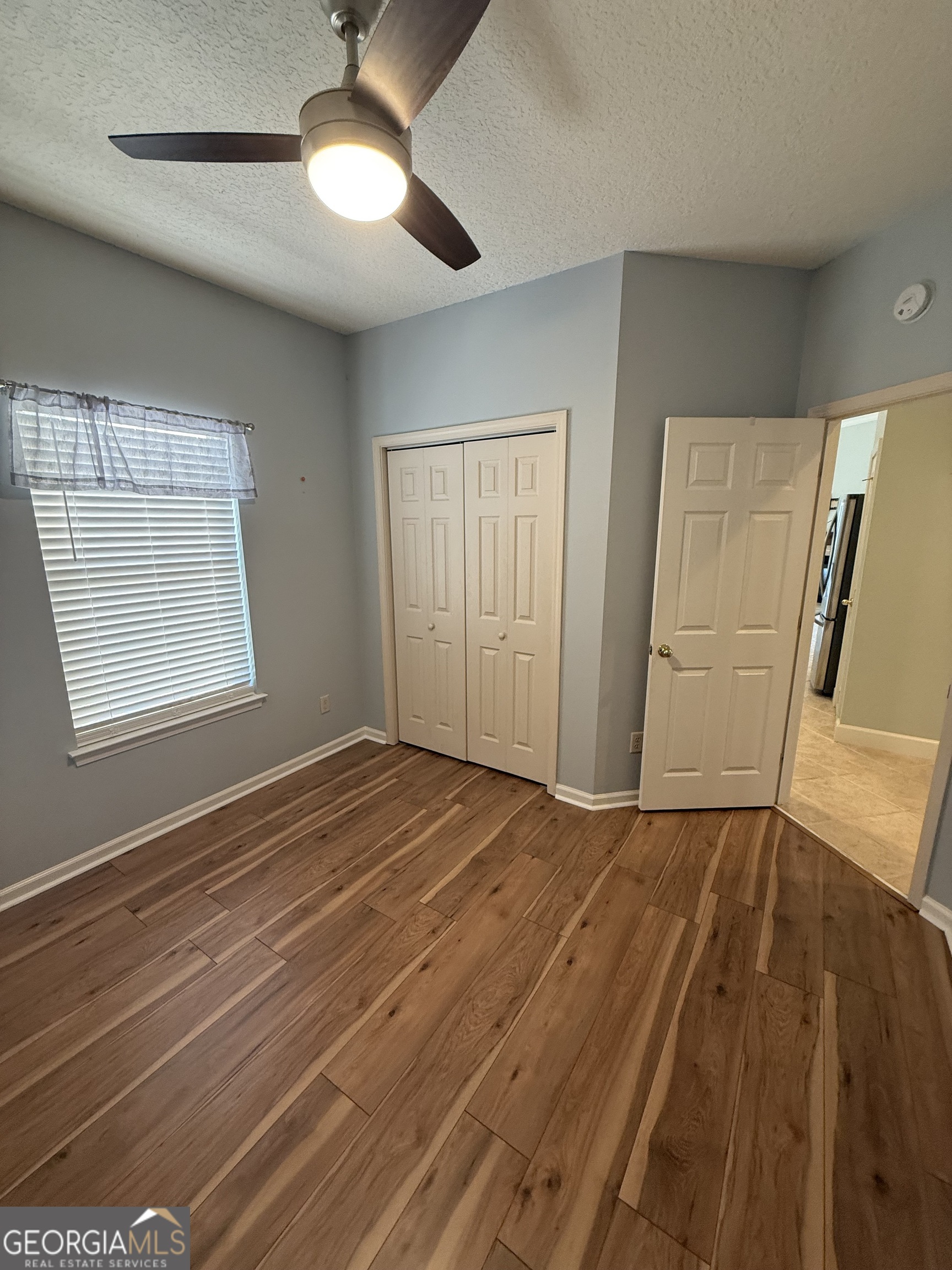 1403 Tanager Trail St. Marys, GA 31558 - Photo 14 of 24 a view of an empty room with wooden floor and a window