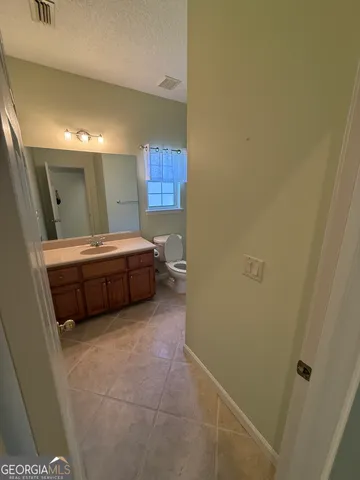 a room with a bed and a mirror