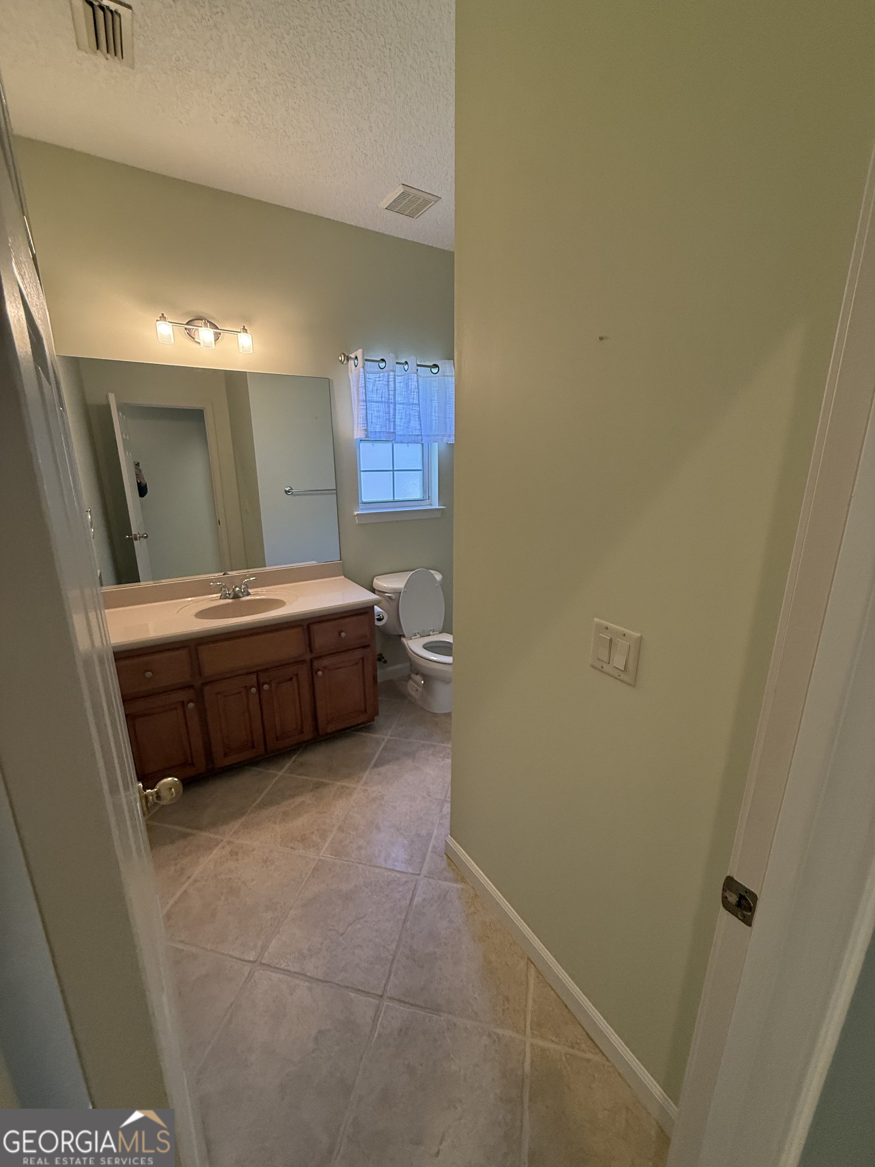 1403 Tanager Trail St. Marys, GA 31558 - Photo 16 of 24 a room with a bed and a mirror