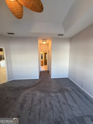 a view of a big room with closet and windows