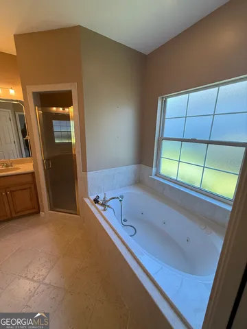 a bathroom with a tub and a sink