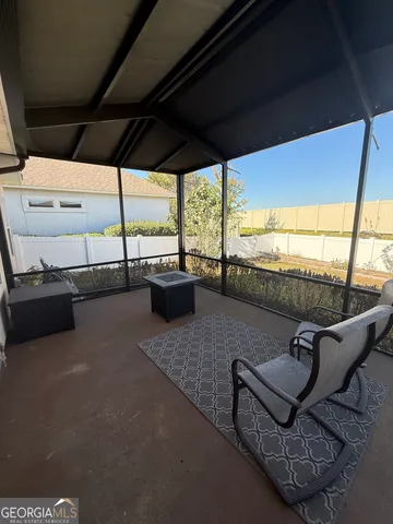 a roof deck with couch and chairs