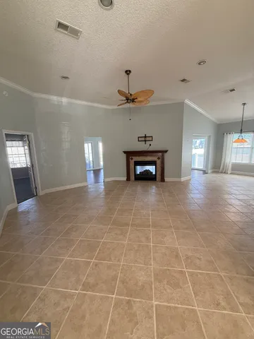 a view of an empty room with a fireplace
