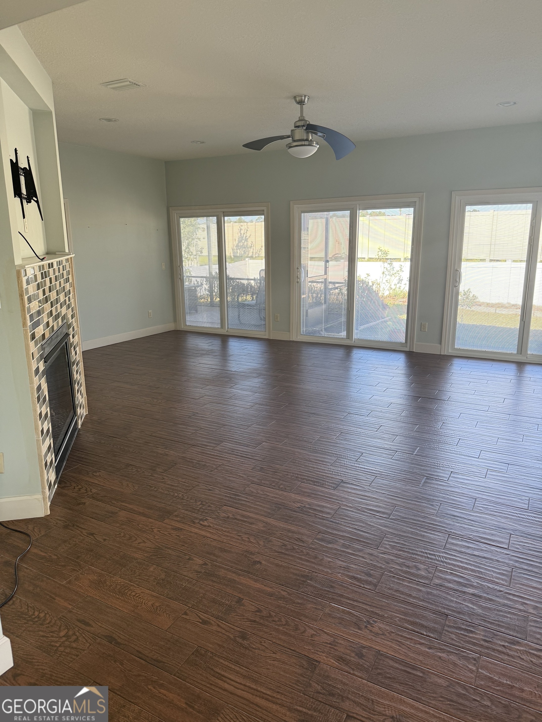 1403 Tanager Trail St. Marys, GA 31558 - Photo 6 of 24 an empty room with wooden floor and windows